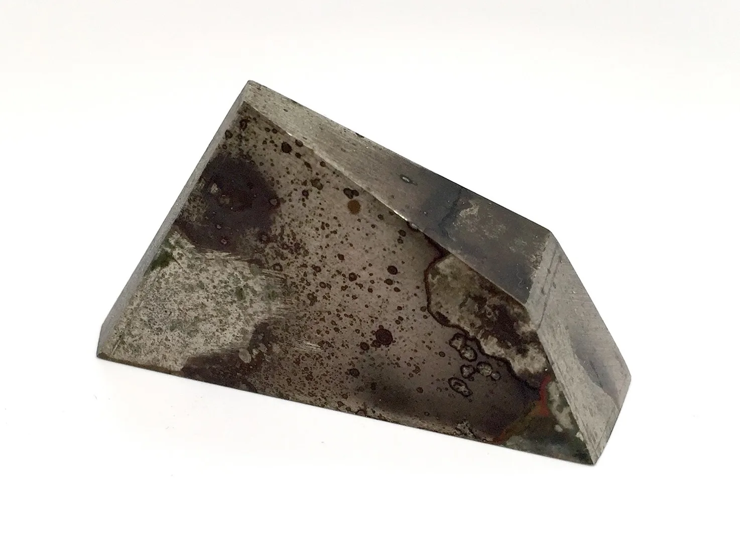 Geometric hexahedral sculpture in nickel silver, surfaces coloured by heat patina, on a white background