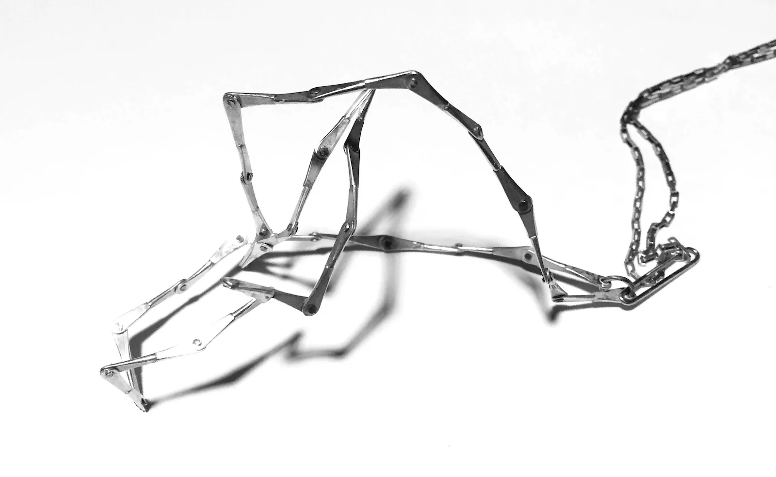 Sterling silver necklace sculpture made of individually riveted segments that can be shaped by hand