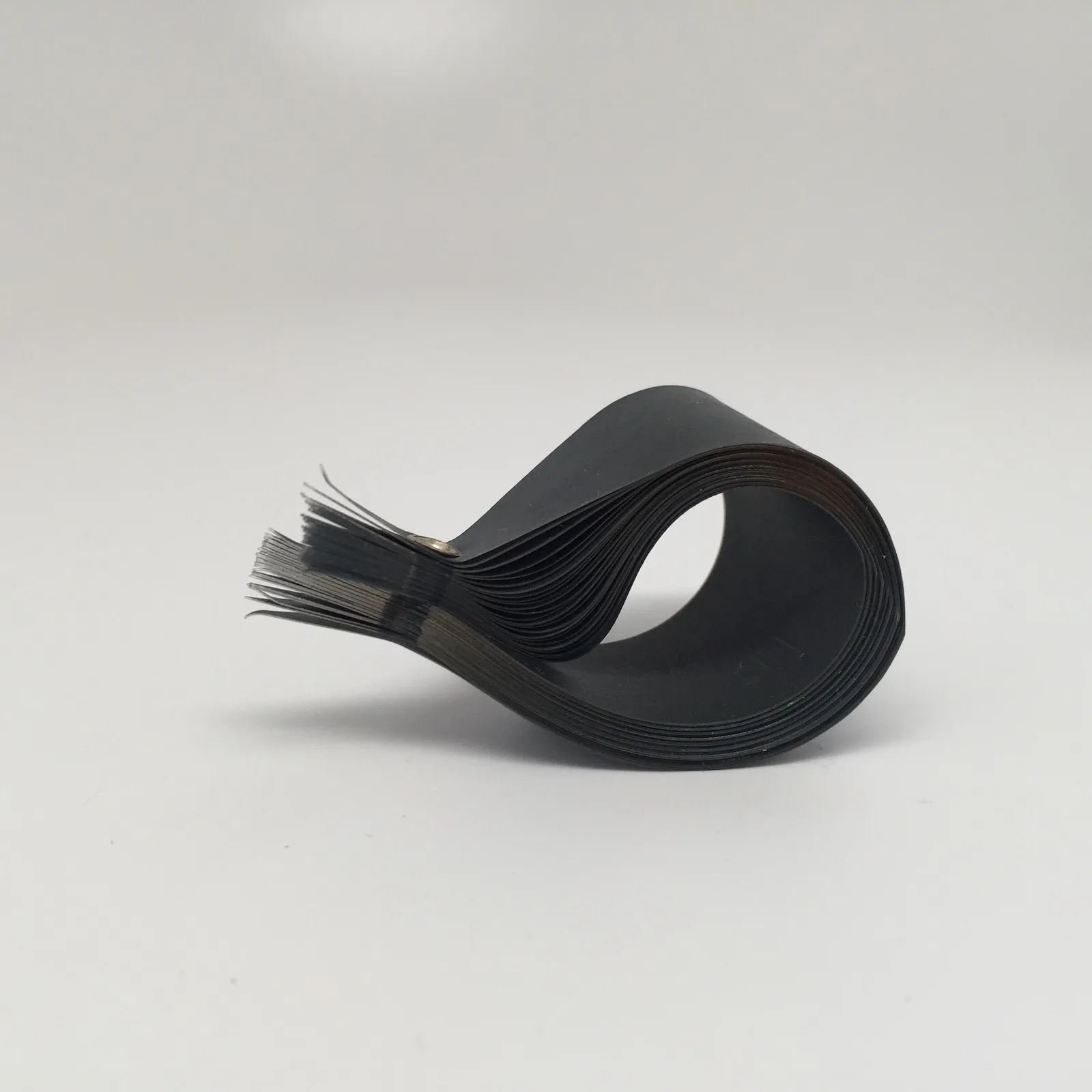 Sculptural ring in Mylar, graphite, and sterling silver