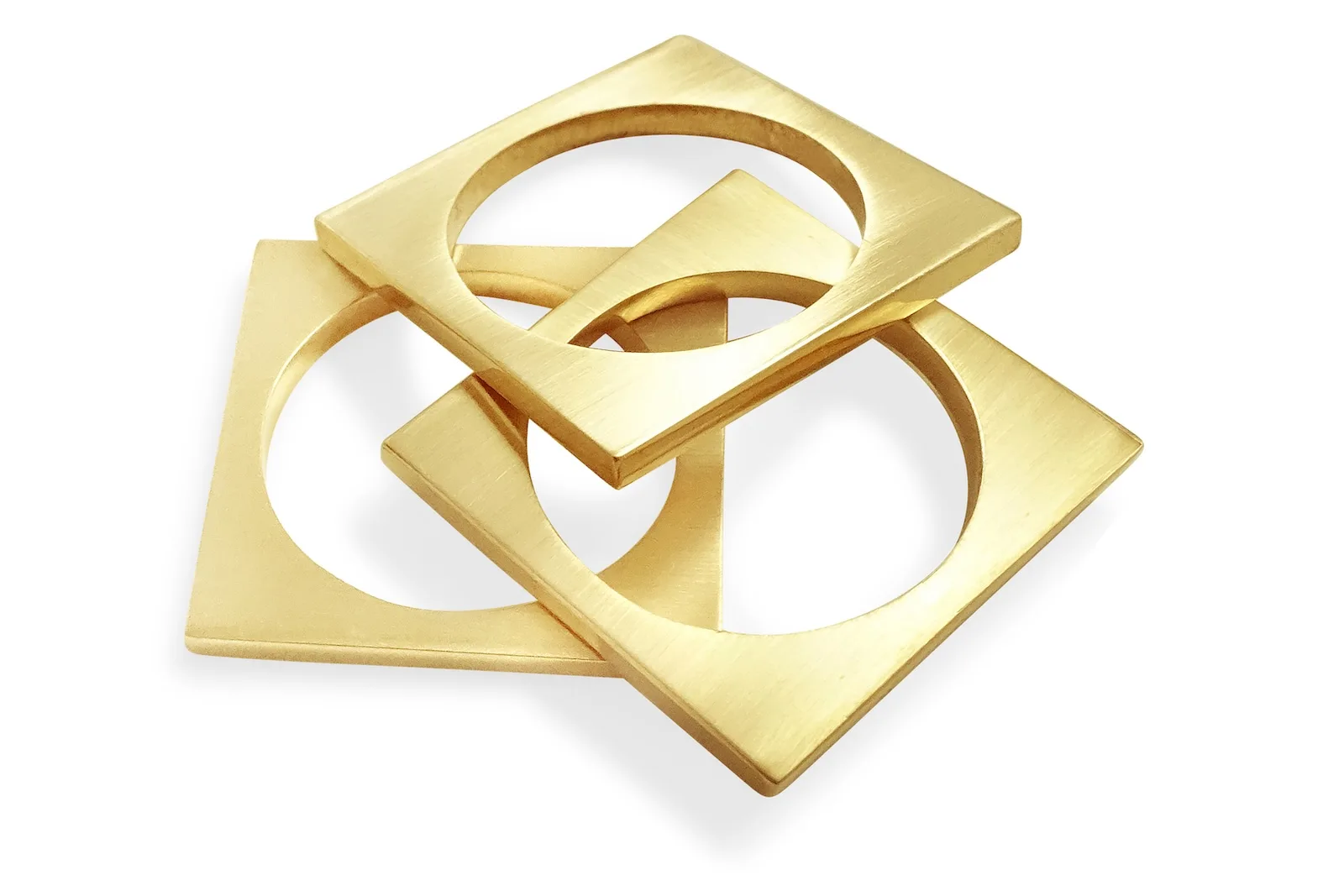 Set of three open gold geometric rings with angular negative space
