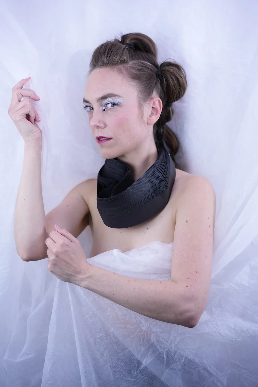 Model in profile with a structured black paper collar sculpture